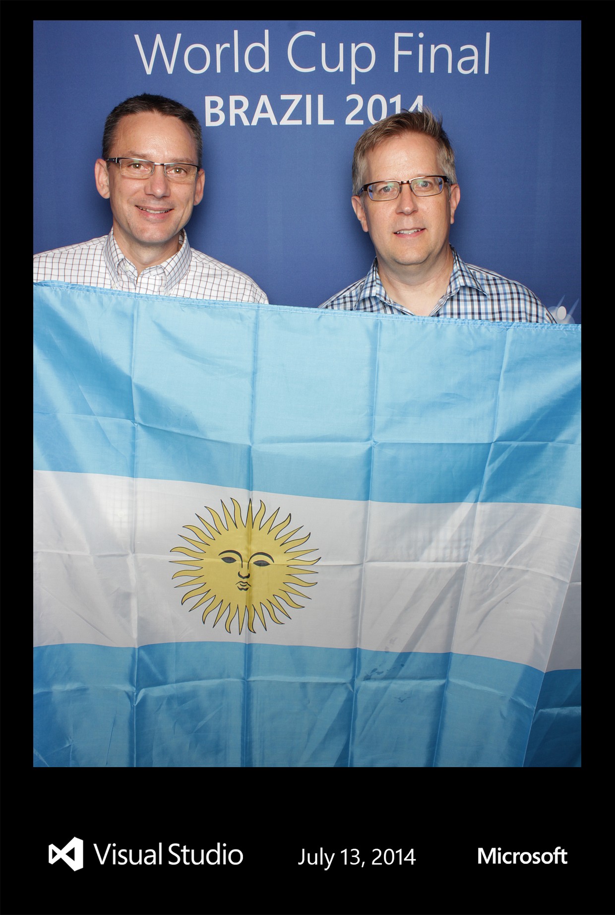 Fans holding a national flag at the World Cup Final photo booth